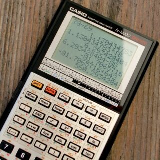 black and grey casio scientific calculator showing formula