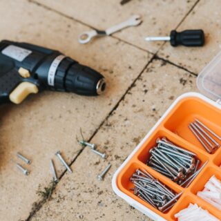 repair tools in container with hammer and screwdriver